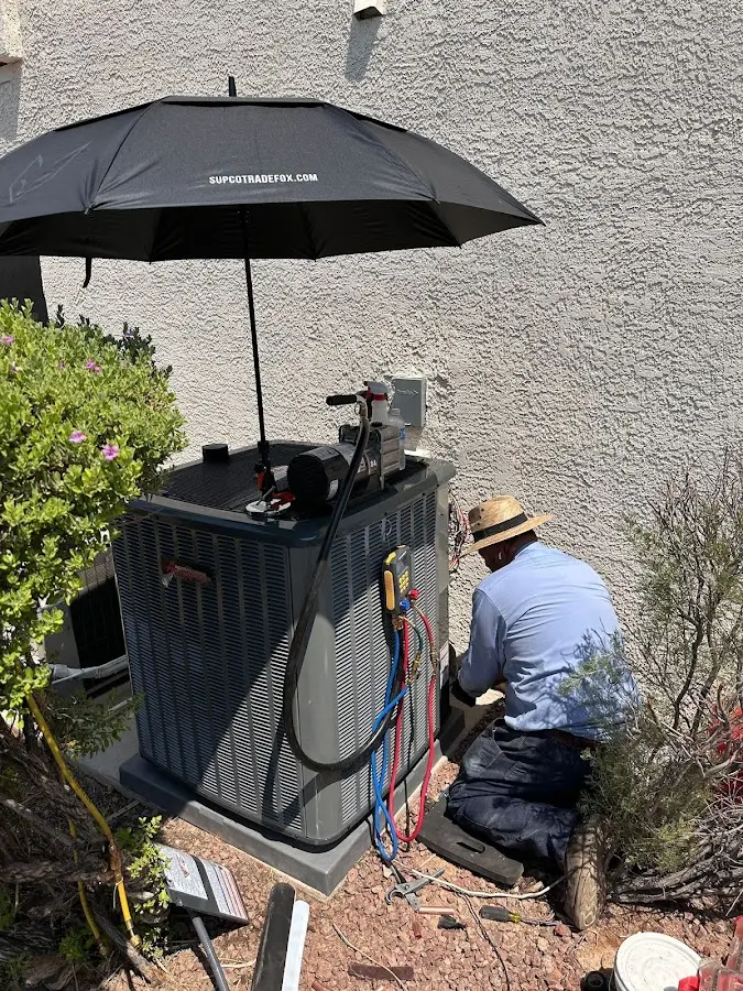 HVAC technician performing outdoor AC maintenance in Gilroy